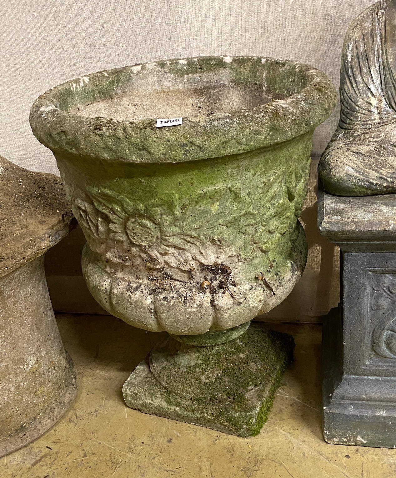 A circular reconstituted stone garden planter, diameter 47cm, height 60cm